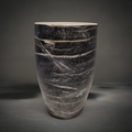 Black Wood Vase — tapered ceramic vase with a smooth glaze reading as charred wood grain, black and grey with pale streaks and a white rim, HMT Home