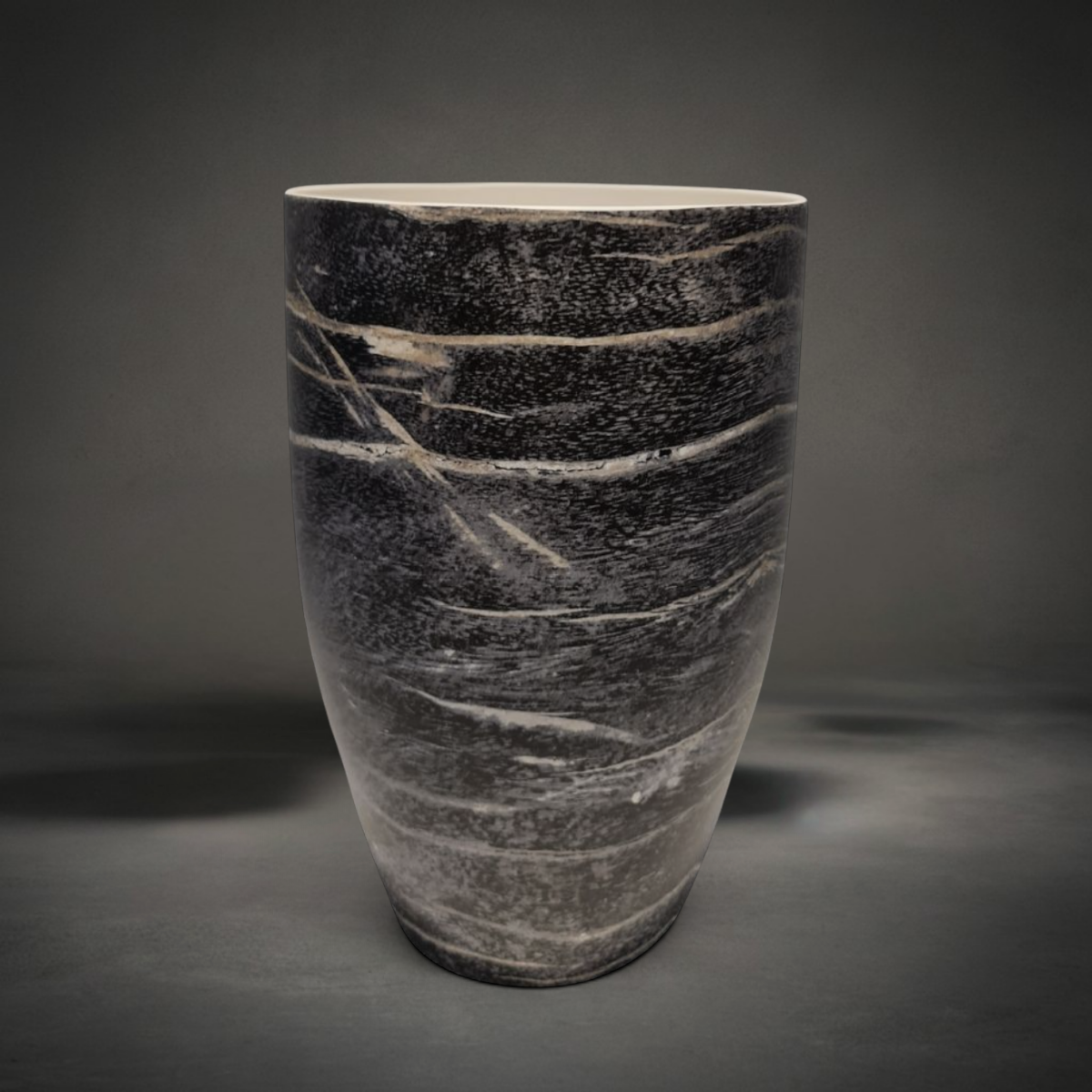 Black Wood Vase — tapered ceramic vase with a smooth glaze reading as charred wood grain, black and grey with pale streaks and a white rim, HMT Home