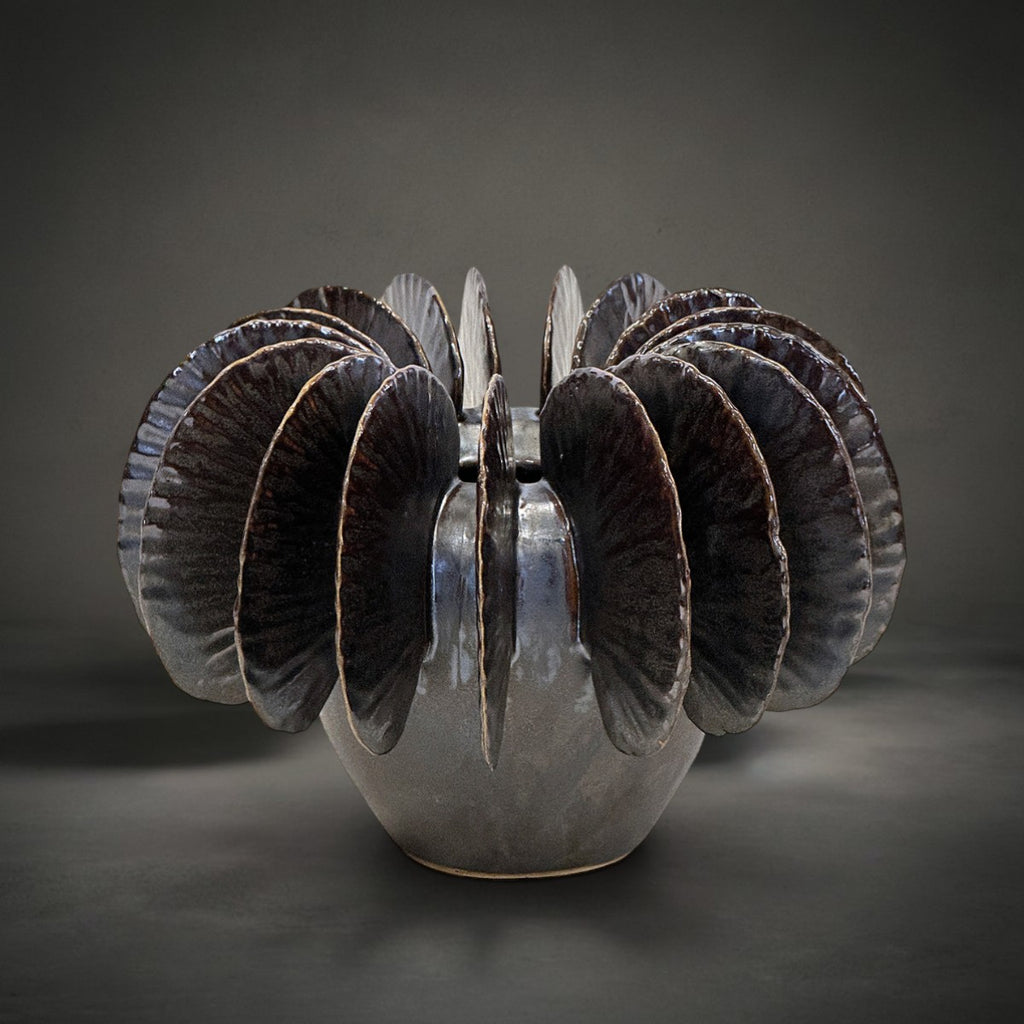 Fin Vase Small — pale grey ceramic vase with bronze metallic glazed fins fanning from the rim, HMT Home