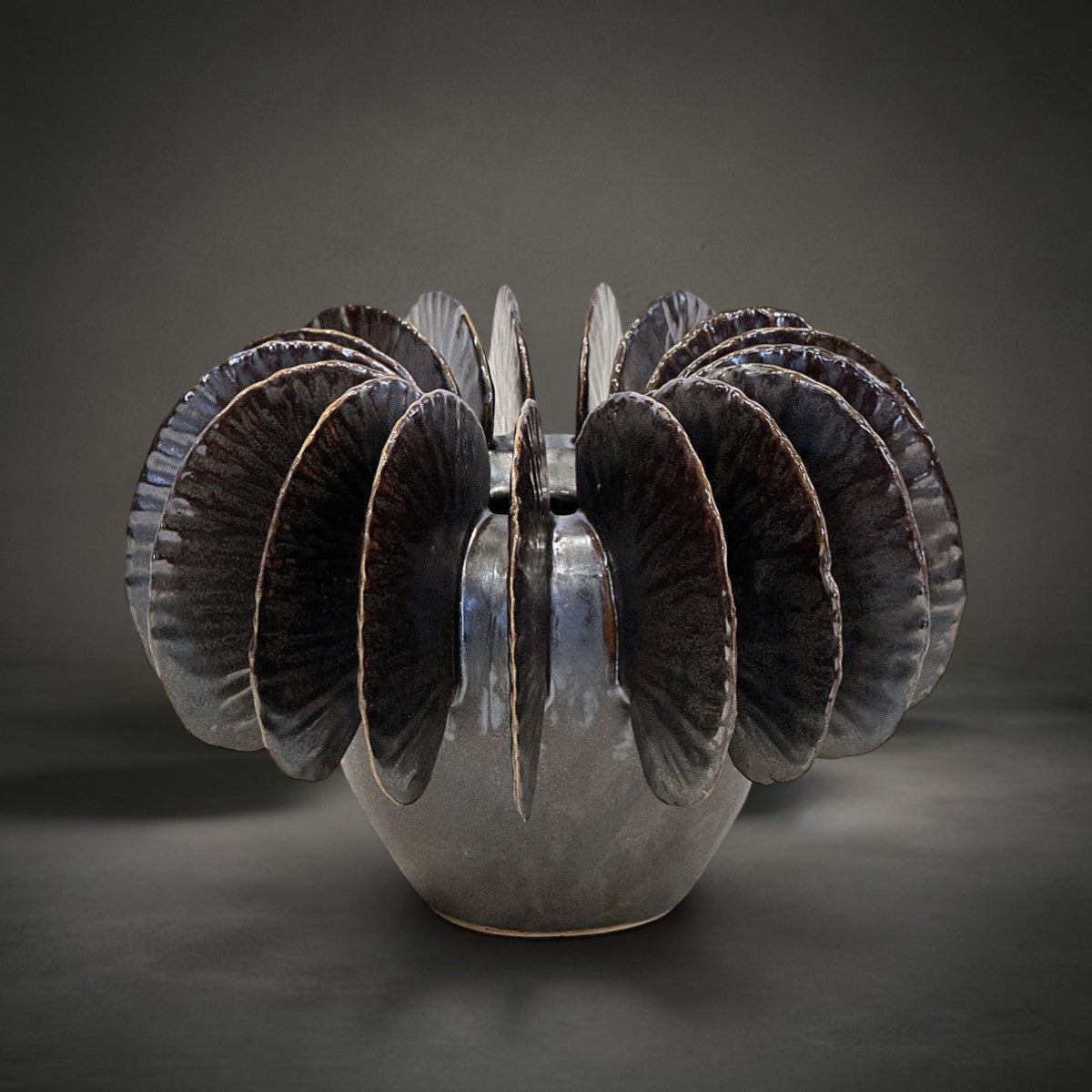 Fin Vase Small — pale grey ceramic vase with bronze metallic glazed fins fanning from the rim, HMT Home